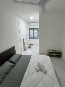 a bedroom with a bed with two pillows on it at Seroja Guesthouse Gambang in Gambang