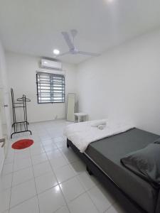 a bedroom with a bed and a ceiling fan at Seroja Guesthouse Gambang in Gambang +9 photos