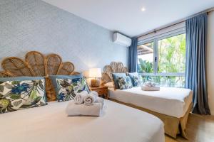 a hotel room with two beds with towels on them at Ixchel Beach House By Sunkeyrents in El Médano