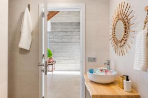a bathroom with a sink and a mirror at Ixchel Beach House By Sunkeyrents in El Médano +48 photos