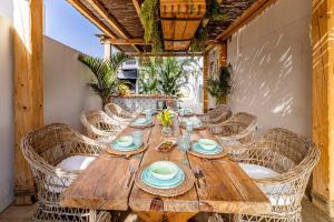 a wooden table and chairs on a patio at Ixchel Beach House By Sunkeyrents in El Médano