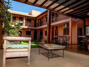 an outdoor patio with a table and a house at Pousada Tapajos Bonito in Bonito