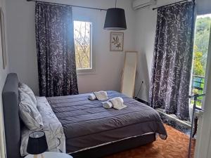 a bedroom with a bed with two towels on it at Serene Country House (near Ancient Tiryns) in Nafplio