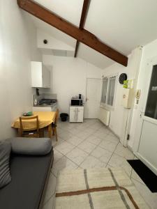 a living room with a table and a kitchen at Close to Paris & Disney & Ofpra in Le Perreux-Sur-Marne