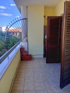 a room with a balcony with a door and stairs at La Casa di Rossella nel cuore della città , Downtown spacious apartment in Olbia