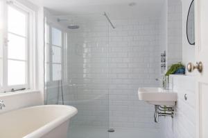 a white bathroom with a tub and a sink at Fern Cottage by Keepers Cottages in Whitstable +21 photos