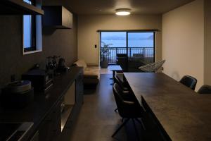 a kitchen and living room with a view of the ocean at PrivateVilla8 in Minamiawaji