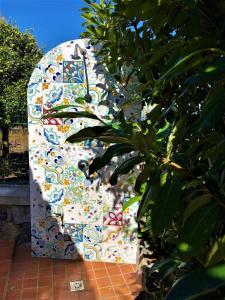 a toilet is covered with a colorful tile at Villa Joyosa Apartments in Ischia Town +48 photos