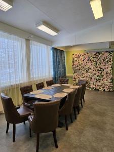 a conference room with a large table and chairs at Hotel Ilomantsi North Star in Ilomantsi