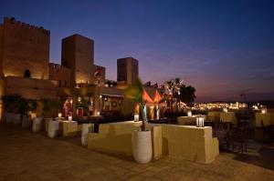 a lit up city at night with buildings and candles at Arobab desert safaris in Ajman 