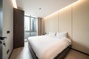Postel nebo postele na pokoji v ubytování Today Aparthotel West Lujiazui Shanghai