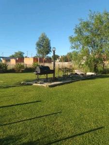 a park with a grill in the middle of a field at Casa de campo y mar in Camet Norte