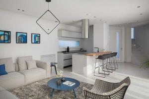 a living room and kitchen with a couch and a table at Villa Georgiana in Funtana