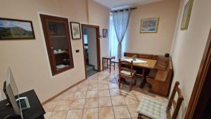 a kitchen and dining room with a table and chairs at Civico3 in Ovada