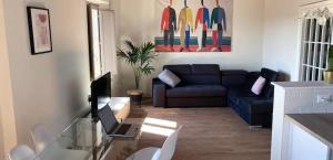 a living room with a couch and a glass table at Palazzo Luparelli Boutique Apartment in Colle Val D'Elsa