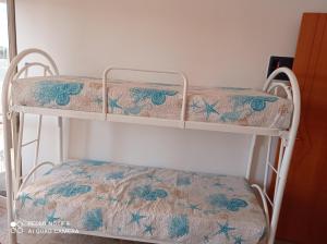 two bunk beds in a room with a seat at Appartamenti Maria 3 in Vieste