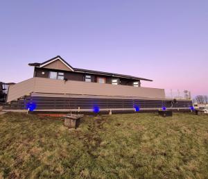 a house with blue lights in front of it at Top Lodge in Newton Stewart