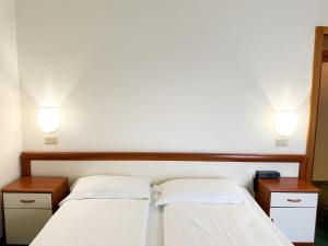 Postel nebo postele na pokoji v ubytování Hotel Bristol