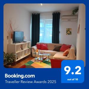 a living room with a couch and a tv at Clockwork orange apartment in Vračar (historical)