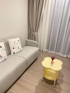 a living room with a couch and a table at Dcondo - Kathu, Phuket in Kathu