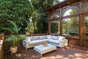 a patio with a couch and a coffee table at Uhu Villa 750 m2 - Budapest in Budapest