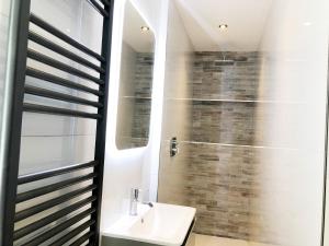 a bathroom with a toilet and a sink and a shower at The Residence Sasco Apartments in Blackpool