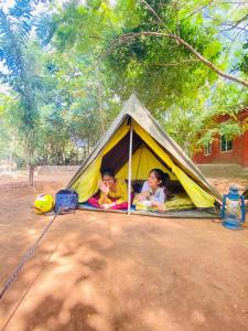two children are laying in a tent at Ziro Festival Camping in Hong
