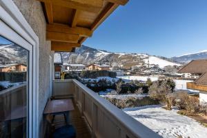a balcony with a view of the snow covered mountains at Lovely Rita, Appartement Kaprun in Kaprun