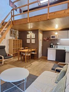 a living room with a couch and a table at Au Gré des Vents - Gîtes et Chambres d'hôtes in Furfooz