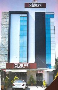 a car parked in front of a building at CLUB 99 SUITES in Kakkanad