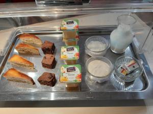 a tray of food with bread and milk on it at Fasthotel Narbonne in Narbonne
