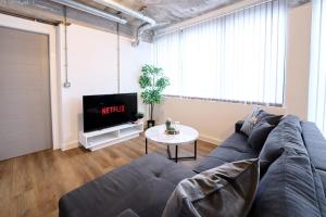 a living room with a couch and a tv at Modern Living 1Bed in Central Warrington in Warrington