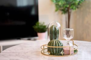 a table with a clock and a wine glass at Modern Living 1Bed in Central Warrington in Warrington
