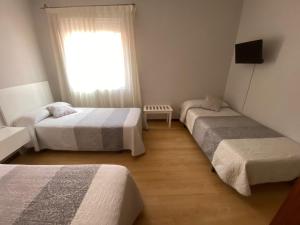 Posteľ alebo postele v izbe v ubytovaní Hotel Cais