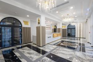 a lobby of a building with a chandelier at CHITULESCU Hotel in Târgovişte