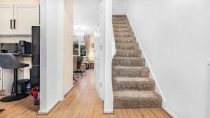 a stairway leading to a living room and a kitchen at Double Bedroom Spacious Home near NEC JLR HS2 BHX Airport with Free Parking and wifi in Solihull +11 photos