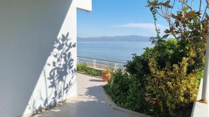a view of the ocean from a house with a pathway at Coastal maisonette in Nea Potidaea