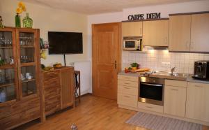 a kitchen with a sink and a stove top oven at Ferienwohnung Freißl in Rottenbuch