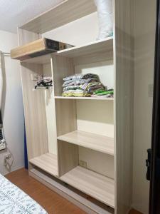 a room with a closet with shelves at AJs One Oasis 1 bedroom in Cagayan de Oro