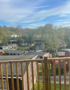 a view of a river from a balcony at Moonlight Lodge in Caeathro