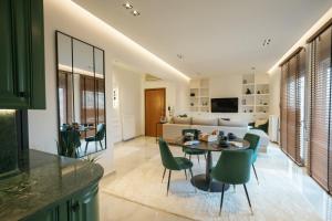 a kitchen and living room with a table and chairs at SeaGreen Luxury Apartment in Alexandroupoli