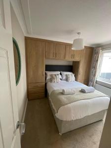 a bedroom with a bed with a headboard at Castlewood Holiday Park in Antrim