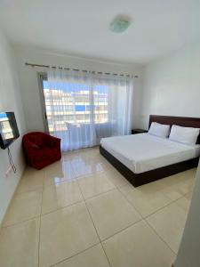 a bedroom with a bed and a large window at Adan Beach Aourir abdelaziz bnafkir in Aourir +16 photos