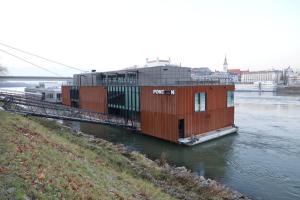 a house on a boat in a river at Ponton Rooms in Bratislava