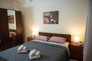 a bedroom with a bed with two towels on it at Green Yard House in Alexandroupoli