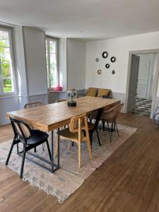 a dining room with a wooden table and chairs at La Rochelle Exceptional Property, Park, Pool, in La Rochelle