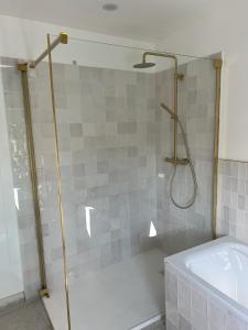a bathroom with a shower with a tub and a sink at La Rochelle Exceptional Property, Park, Pool, in La Rochelle +29 photos