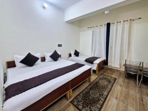 Postel nebo postele na pokoji v ubytování Hotel Aashirwad