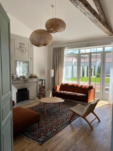 a living room with a couch and a table at La Rochelle Exceptional Property, Park, Pool, in La Rochelle