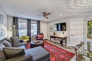 a living room with a couch and a desk at Comfortable and stylish condo near Myers Park in Charlotte +33 photos